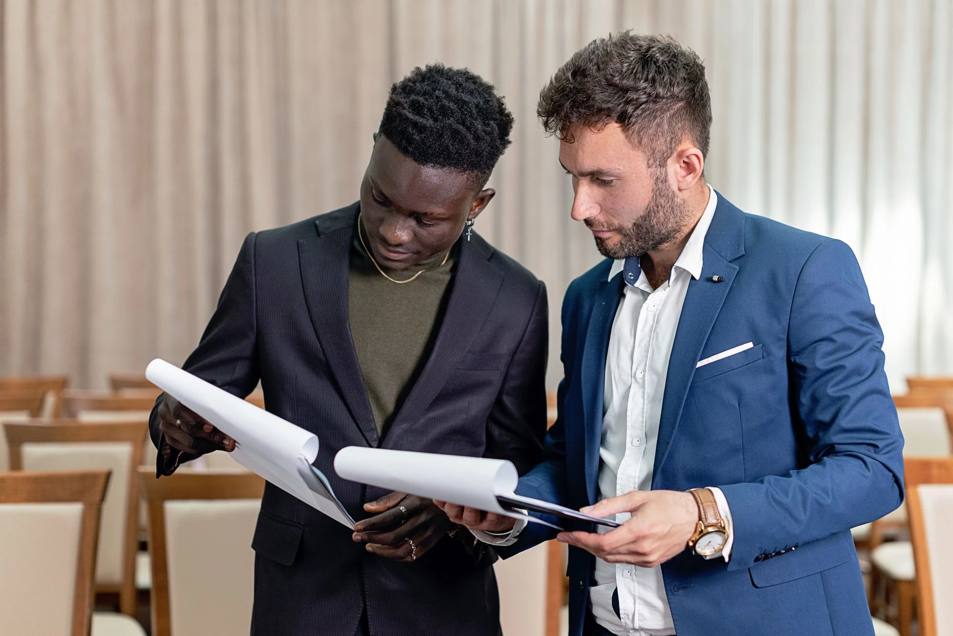 Two professionals reviewing business documents together