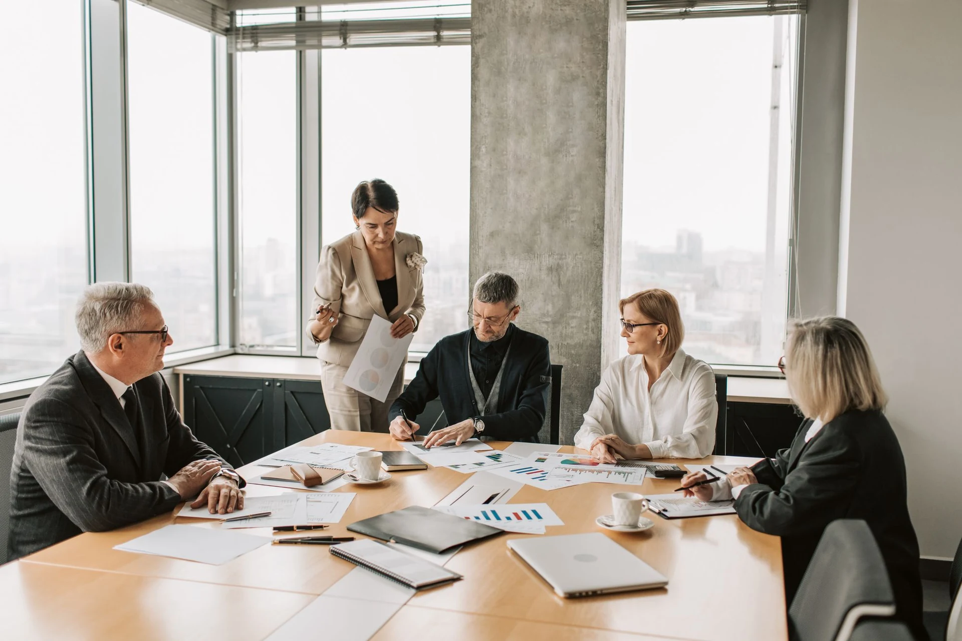 Professionals discussing financial reports around a table